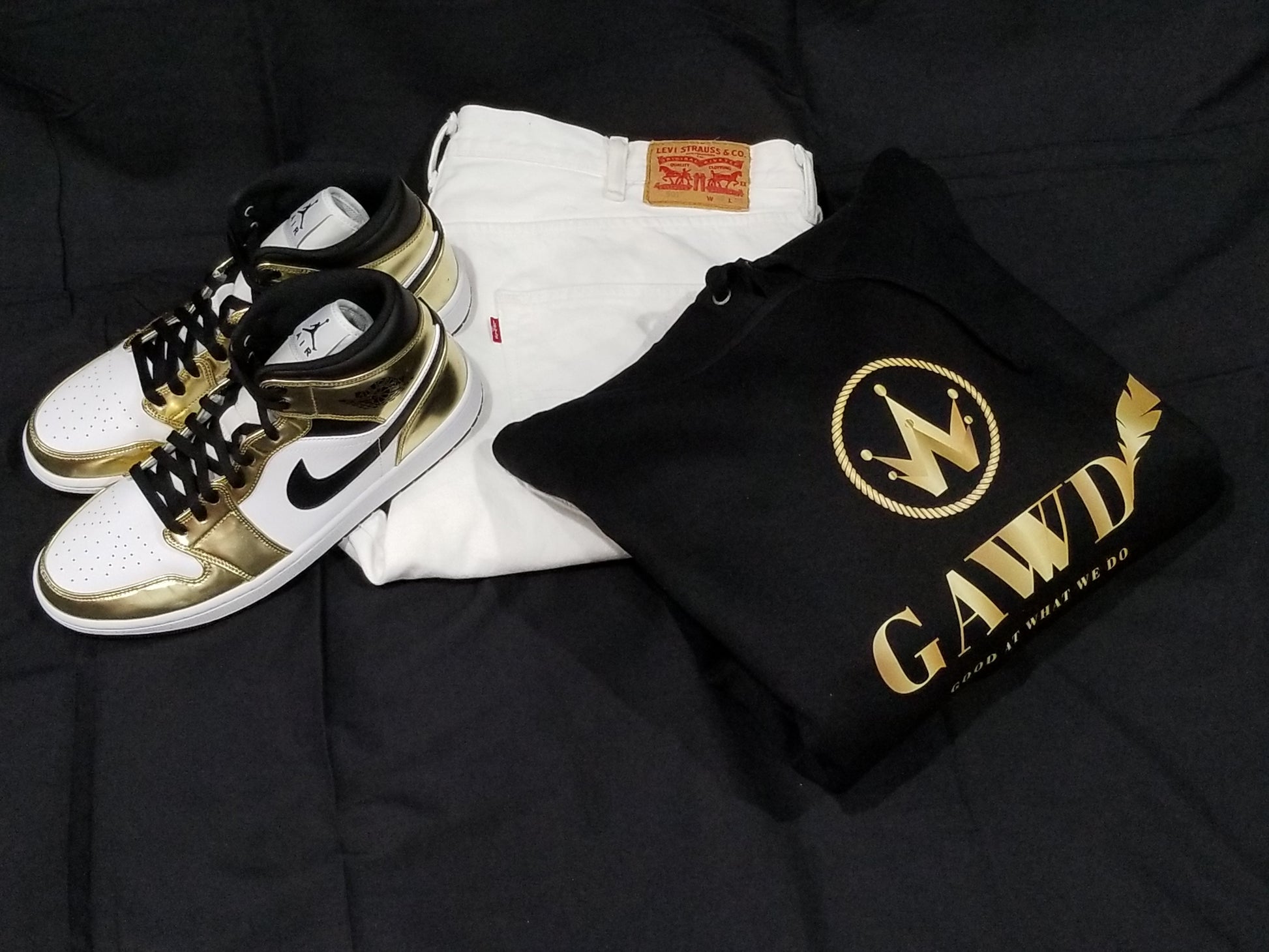 Black Hoodie with Gold Logo GAWWD (Good At What We Do) with white jeans and gold and black Air Jordan 1's